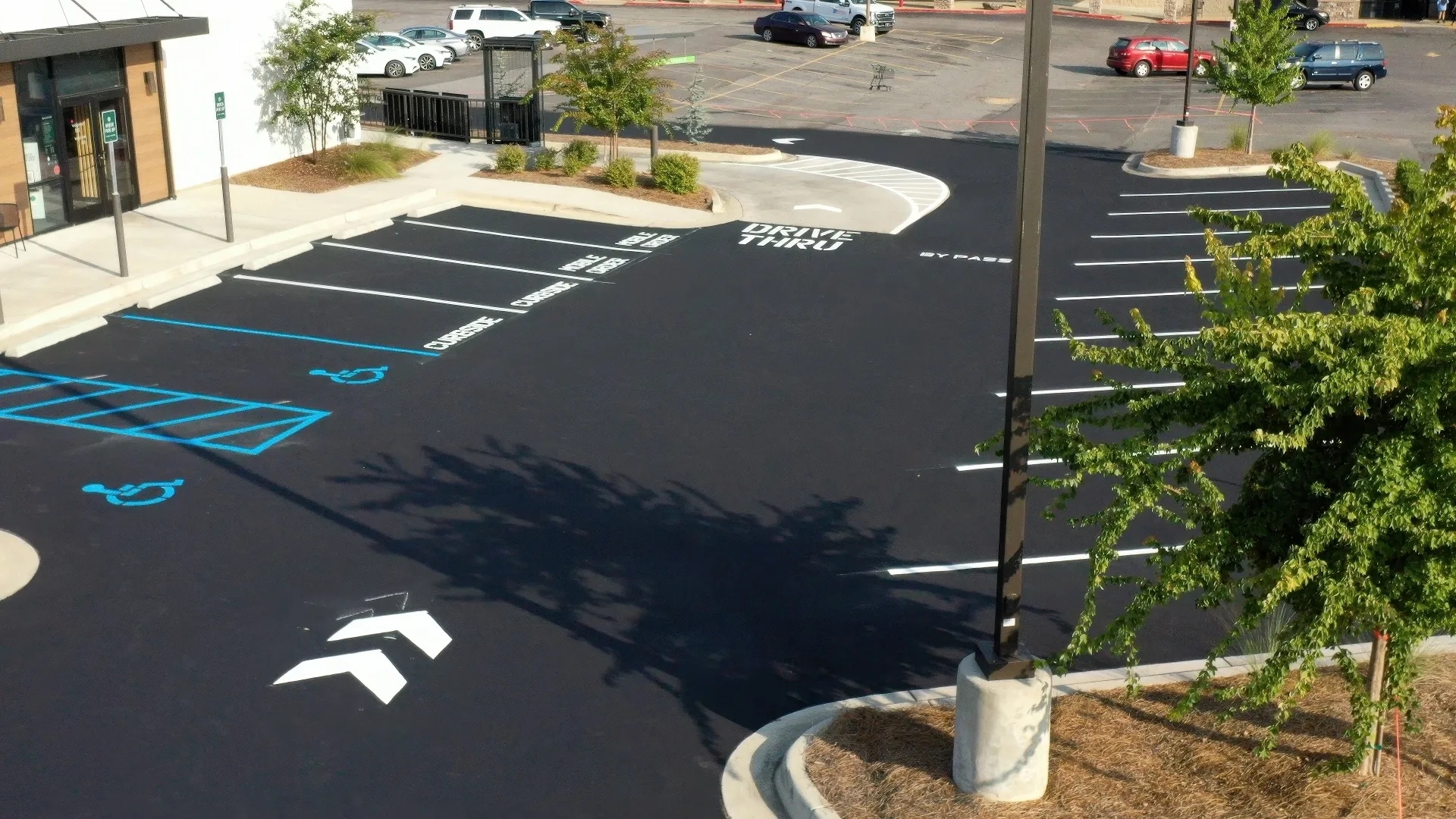 Appell franchise starbucks parking lot line striping A clean parking lot with designated spaces for drive-thru, curbside, and accessible parking, featuring clear markings and