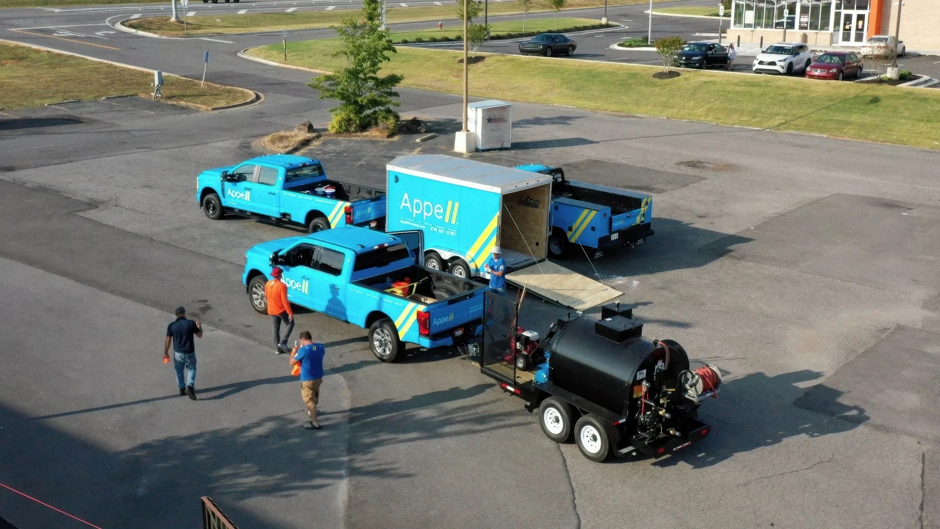 Appell striping franchise territory line striping Aerial view of Appell franchise vehicles and equipment in a parking lot.