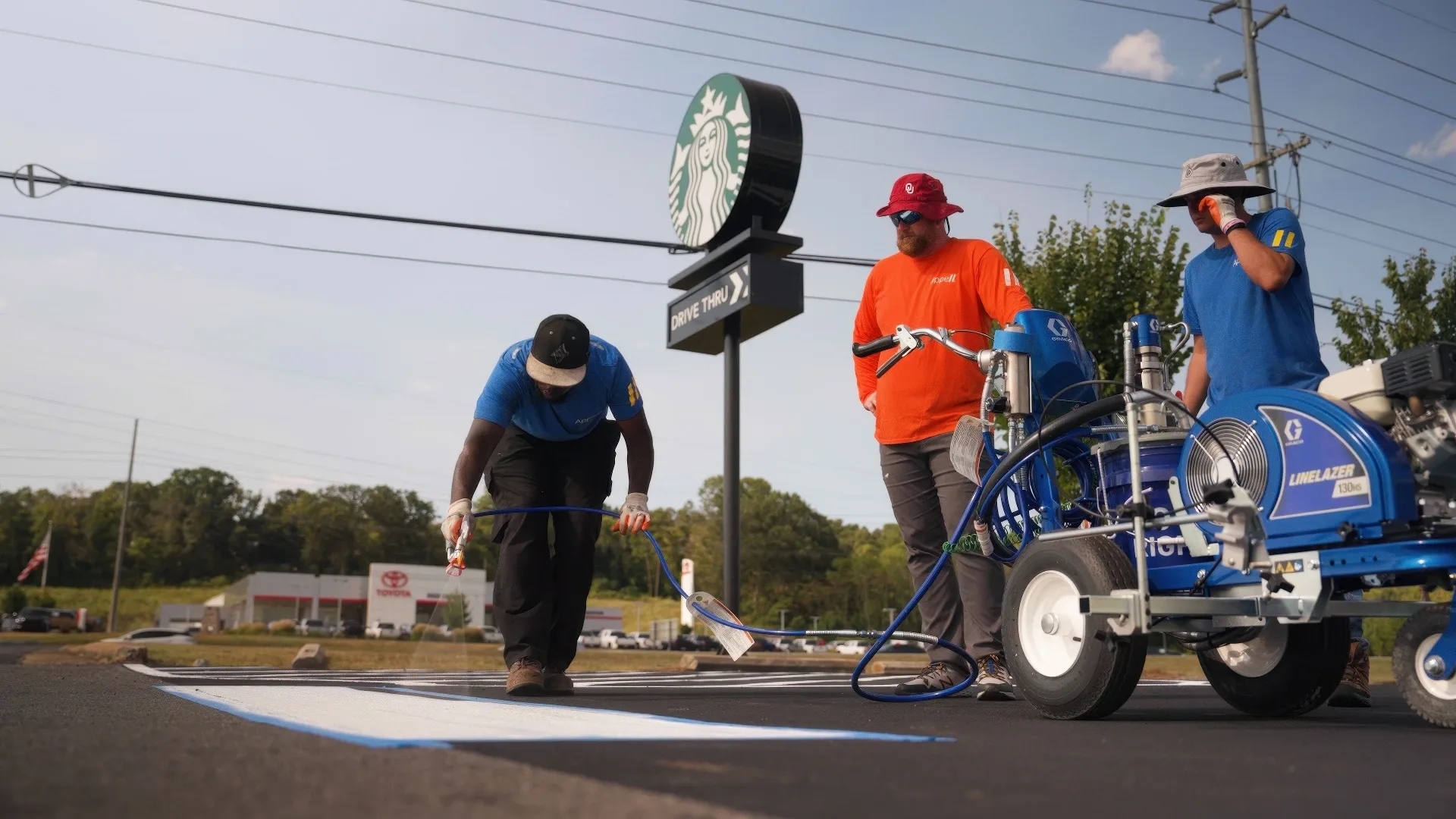 Appell striping line striping franchise team A franchise team working on painting a crosswalk with a professional street painting machine.